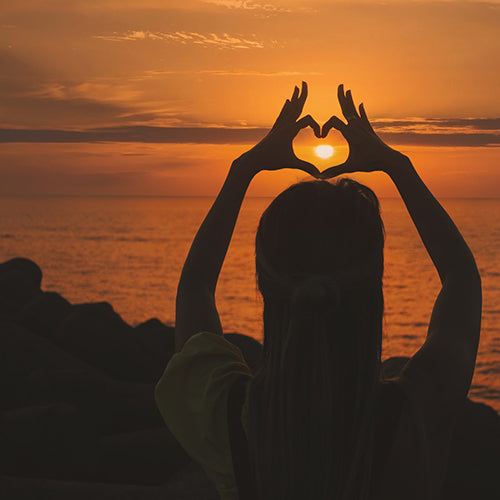 Heart hands at sunset - cardiovascular health benefits of curcumin