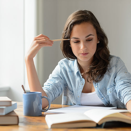 Woman studying with focus - curcumin cognitive and memory support