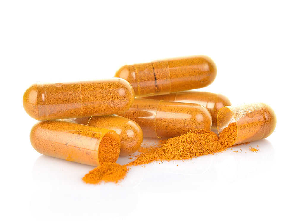 Curcumin capsules laying open on table
