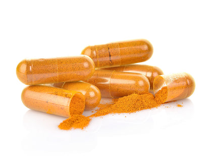 Curcumin capsules laying open on table