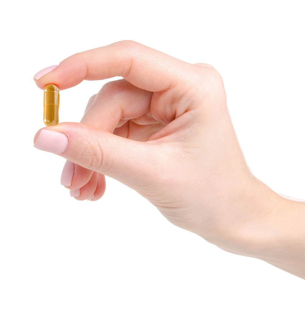 Hand holding NanoCur Curcumin Capsule